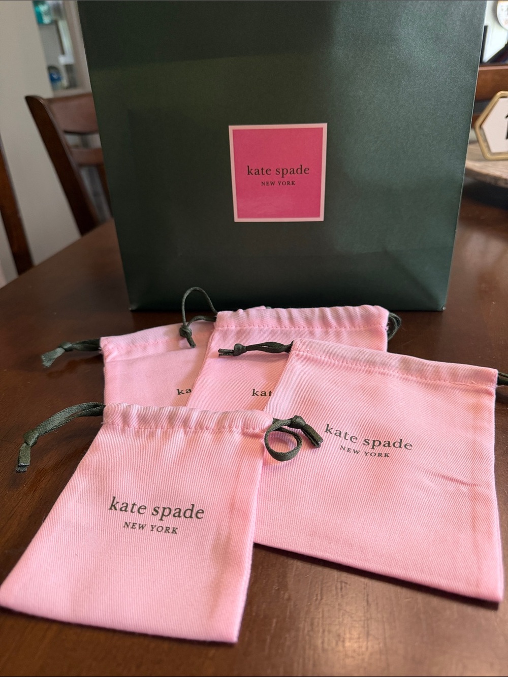 kate spade pink jewelry pouches with dark green gift bag